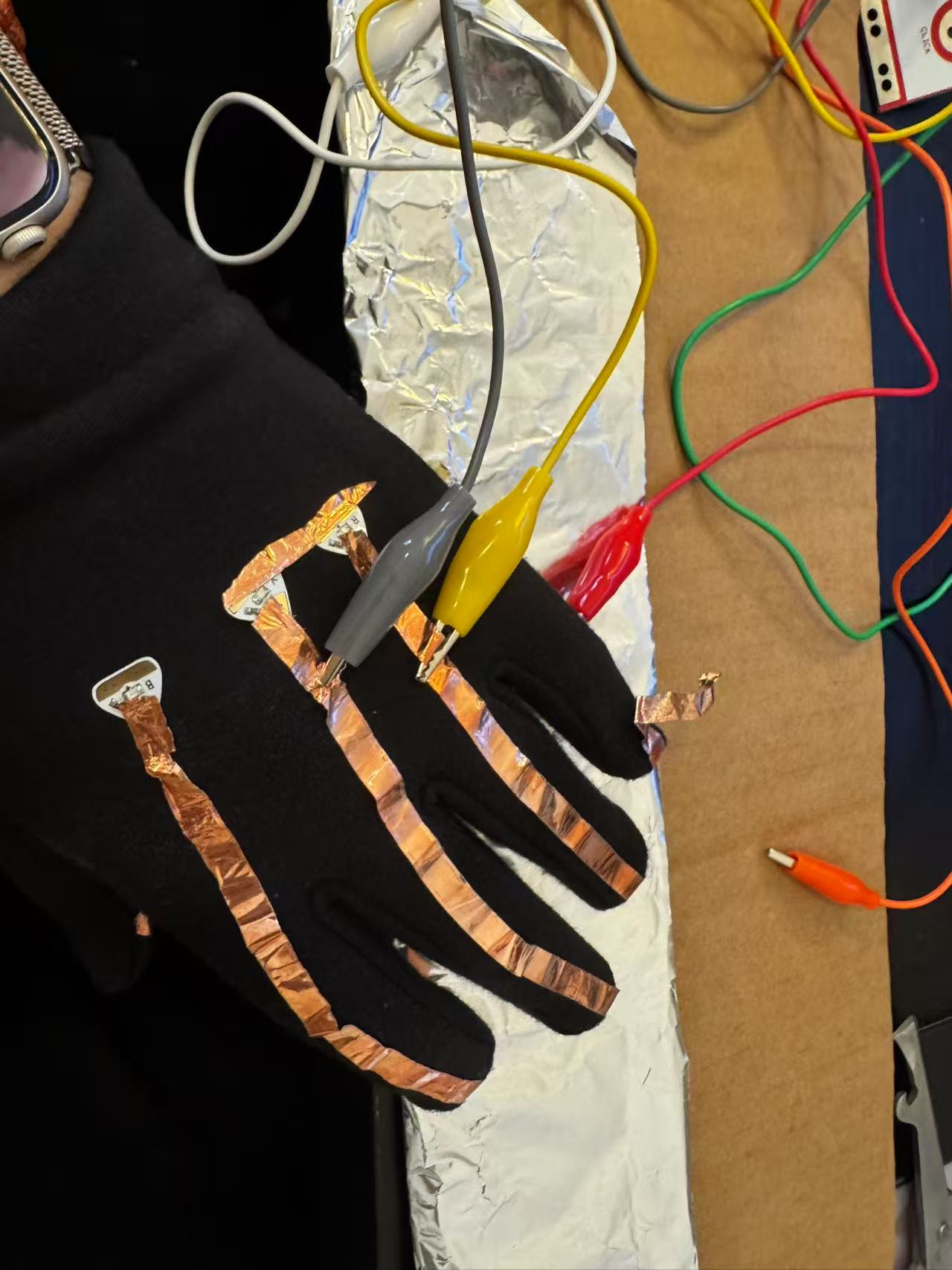 Explore conductive materials - copper wire and gloves combined together